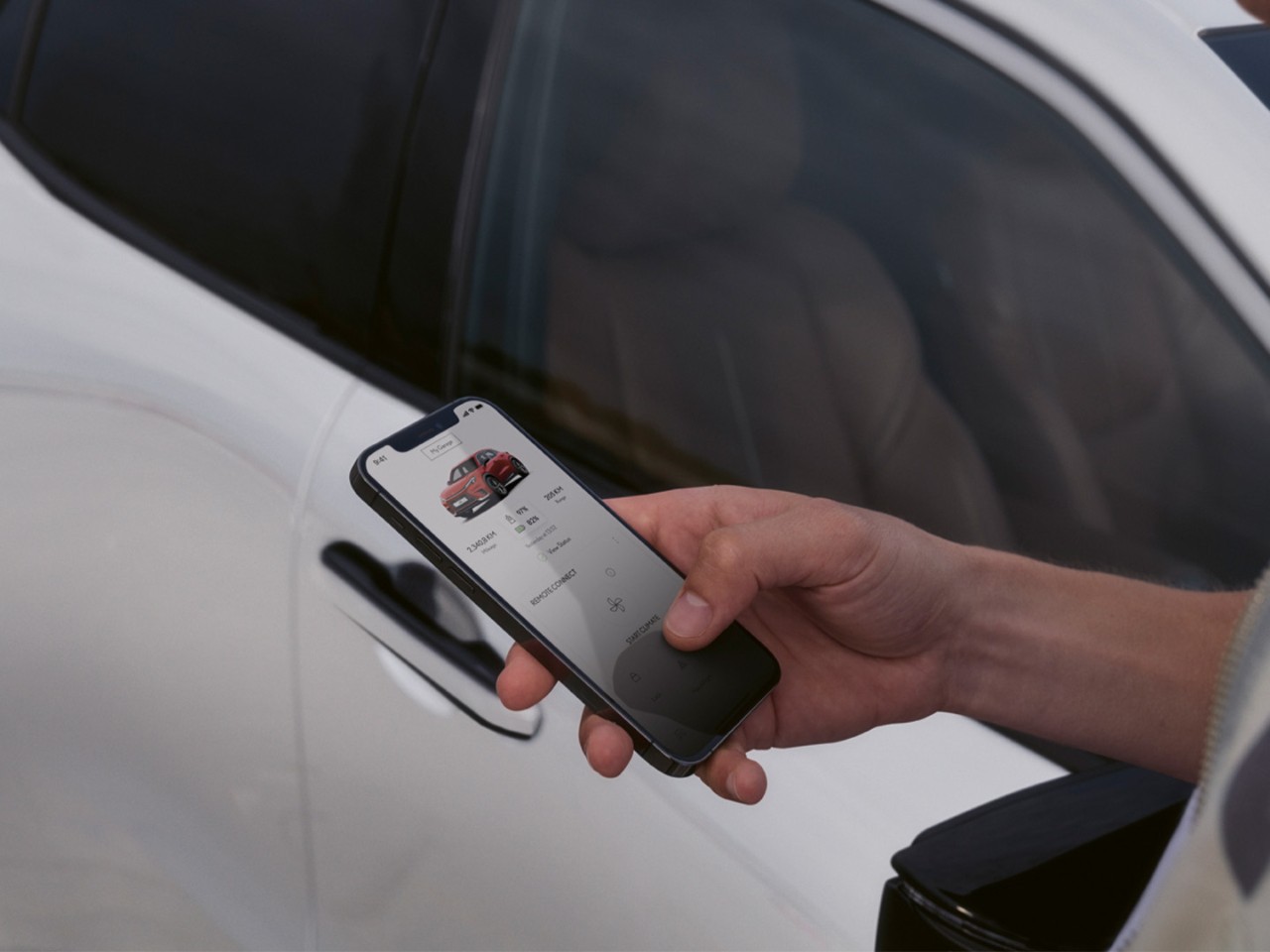 A person using a mobile phone to access the Lexus Link+ app
