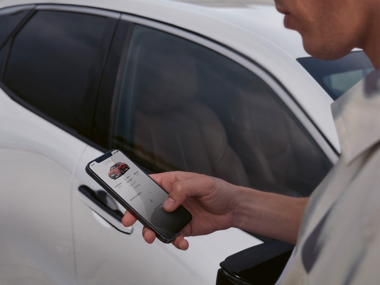 A person using a mobile phone to access the Lexus Link + app